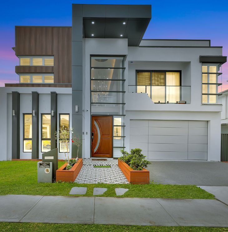 Two-storey home with rendered façade, timber cladding and feature entry, built by LA Elegant Homes