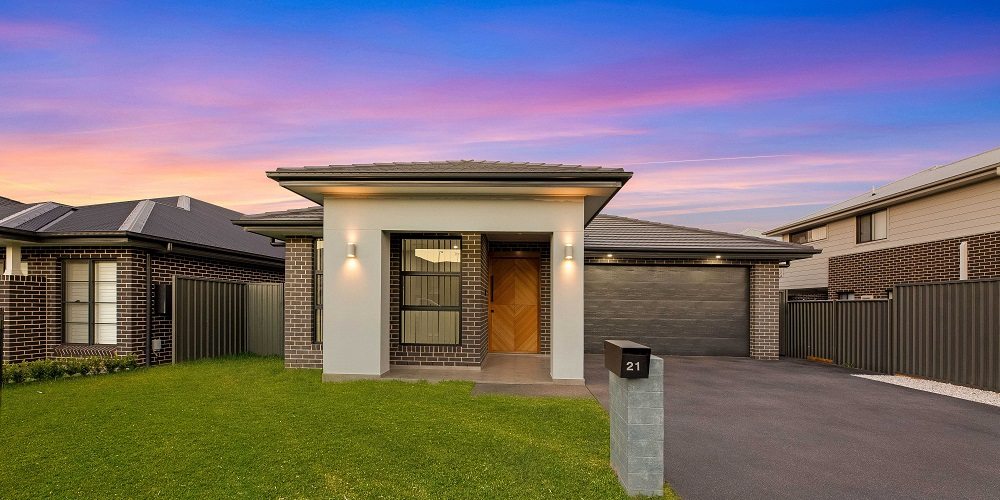 Completed custom home at Gregory Hills photographed at dusk, built by LA Elegant Homes