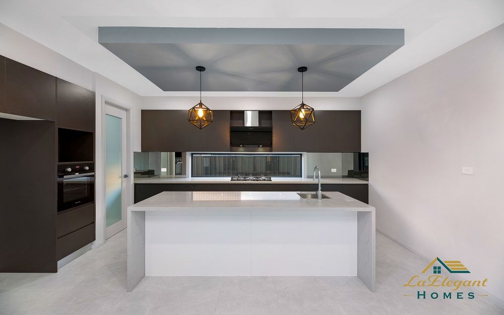 Kitchen with dark timber-look joinery, stone island bench and geometric pendant lights