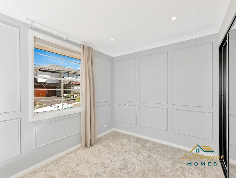 Bedroom with wall panelling, carpet and a mirrored built-in wardrobe