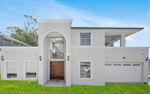 Modern custom home with rendered façade and timber entry, built by LA Elegant Homes