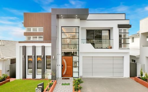Two-storey designer home with mixed timber and render façade and feature entry door